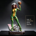 A 1/4 scale painted collectible figurine of a female superhero in a green and gold bodysuit holding a basketball, posed on a base with a basketball hoop and a comic book, against a dark studio background with text overlay detailing product info.